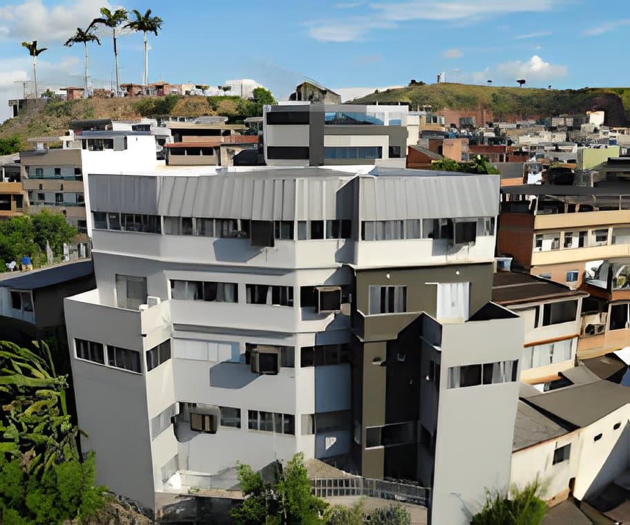 Prédio da fábrica Corpo Sensual entre as casas do bairro Dornelas, em Muriaé, com os morros ao fundo